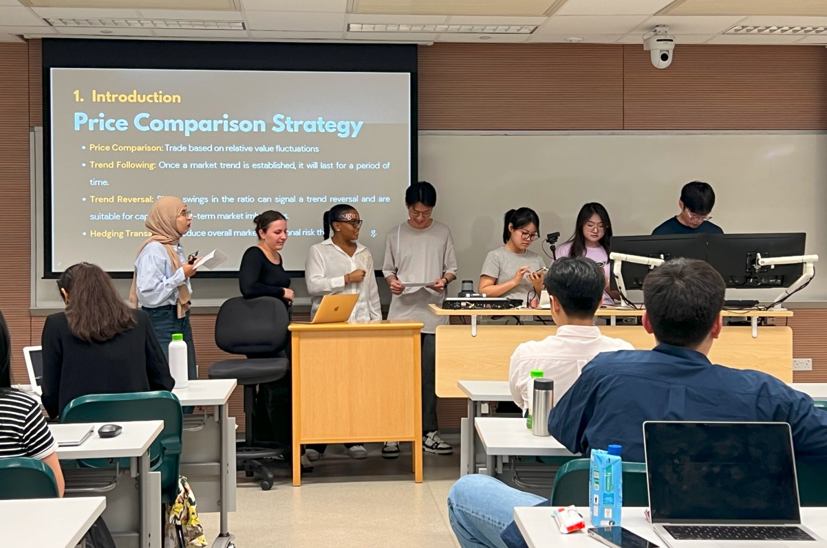 Students in a FIN 7850 classroom session, working on laptops during the practical exercise